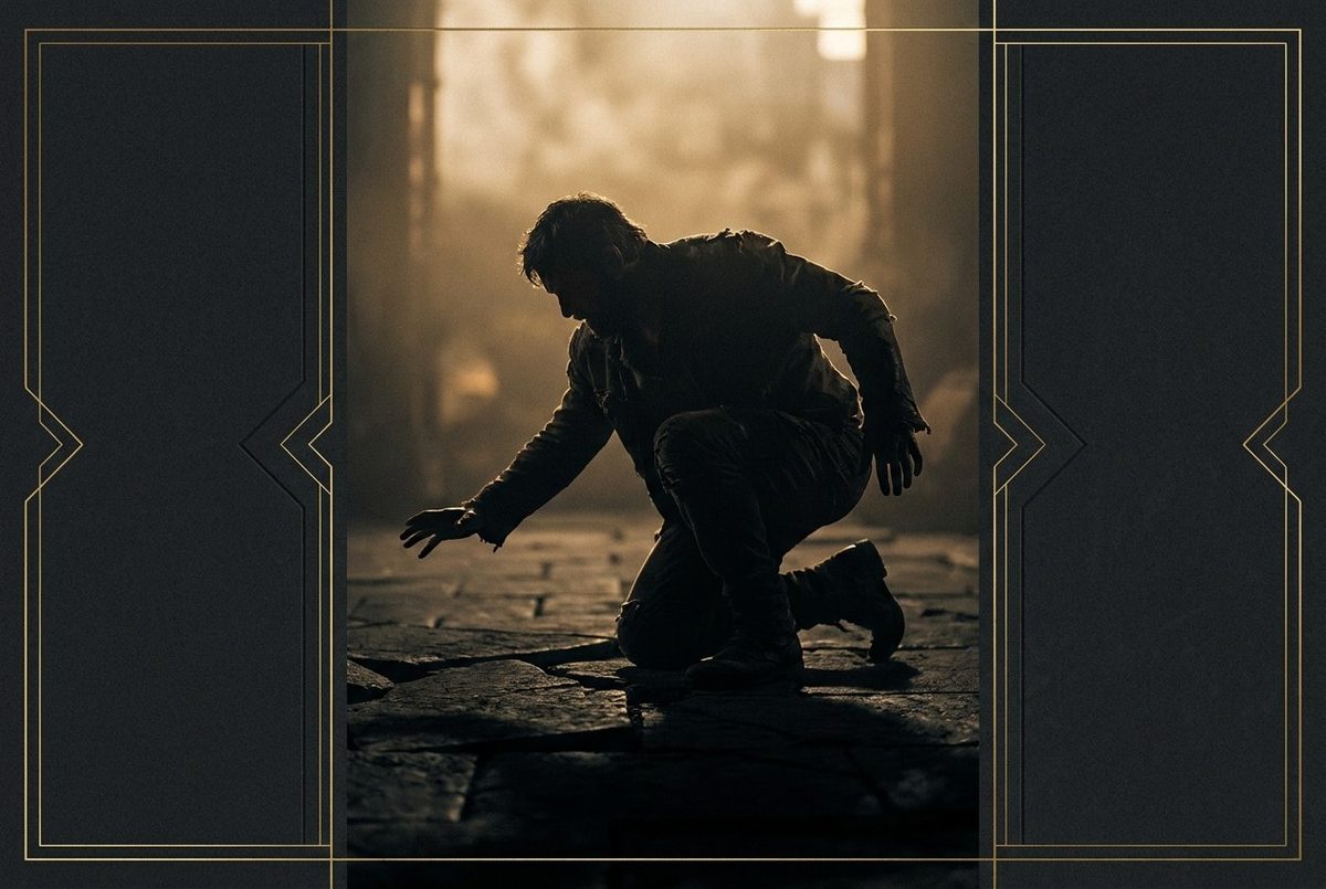 A man on his knees, laying a floor